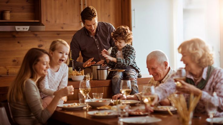 a group of people sitting around a table eating food