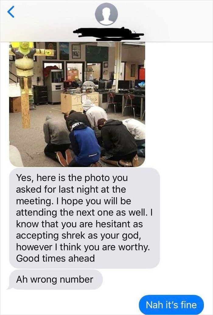 two people sitting on the floor with their backs to each other, one person is texting