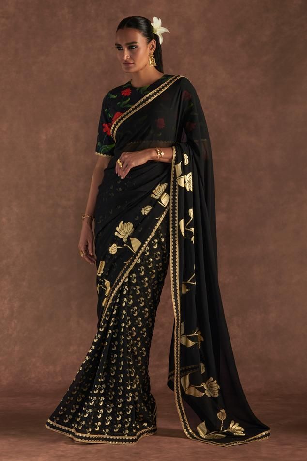 Black saree with placement springbud floral foil prints and embroidered border. Comes with printed blouse piece.
Components: 2
Pattern: Foil Printed, Embroidered
Type Of Work: Springbud
Fabric: Saree- Georgette, Blouse Piece- Raw Silk
Color: Black
Other Details: 
Note: Stitched blouse worn by the model is not for sale
Disclaimer: The actual print-placement and colour of the product may vary slightly from the image shown.
Occasion: Reception - Aza Fashions Masaba Gupta, Saree Georgette, Foil Prints, Georgette Blouse, Embroidered Border, Black Saree, Statement Jewellery, Print Placement, Designer Gowns