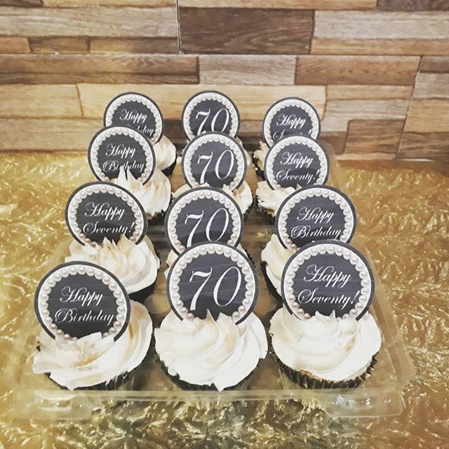 cupcakes with white frosting and black numbers on them