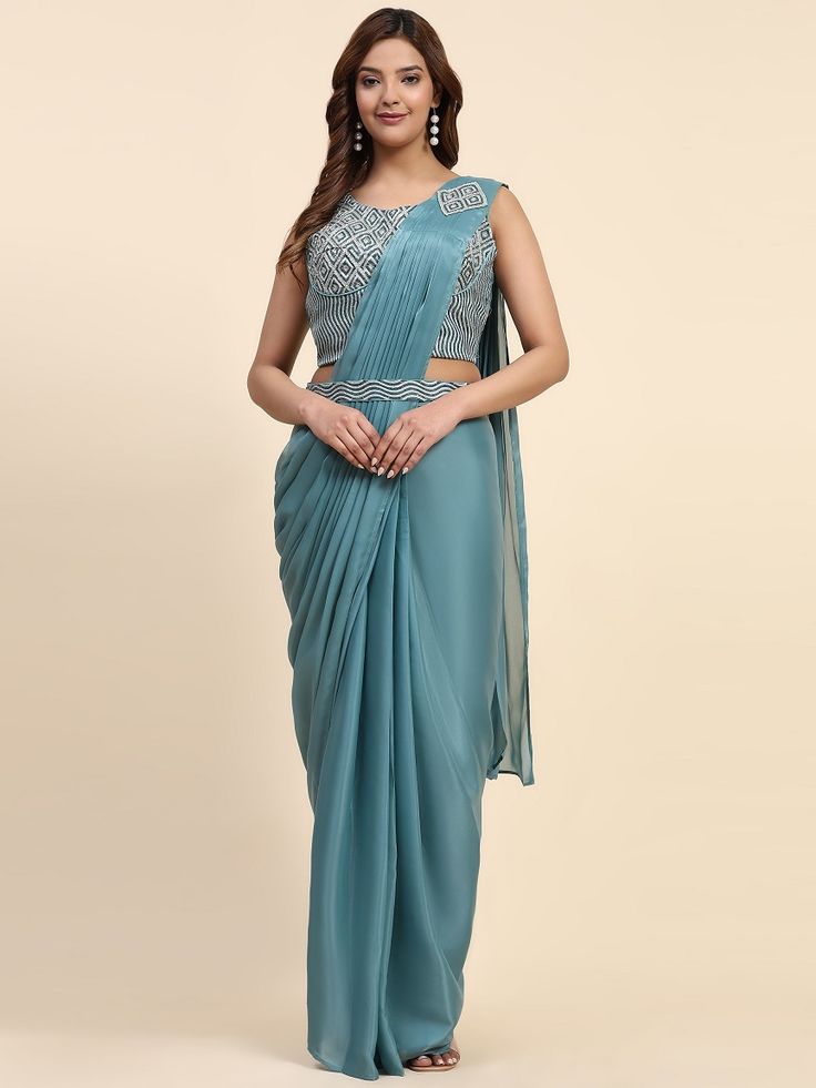 Stitched Saree with blouse in blue colour A329 A full-stitch drape saree is a contemporary take on the traditional Indian saree, combining the elegance of the drape with the convenience of a pre-stitched garment. This innovative design features a pre-pleated pallu and a stitched skirt, offering ease of wear without compromising on style. Ideal for modern women who appreciate the grace of a saree but seek practicality in their attire, the full-stitch drape saree allows for effortless draping and Traditional Blue Pre-draped Saree For Party, Blue Traditional Pre-draped Saree For Party, Blue Pre-draped Saree For Festive Evenings, Blue Georgette Pre-draped Saree For Evening, Blue Party Wear Choli With Traditional Drape, Blue Bollywood Blouse For Formal Occasions, Blue Floor-length Party Wear Saree, Festive Blue Art Silk Pre-draped Saree, Blue Bollywood Formal Blouse Piece