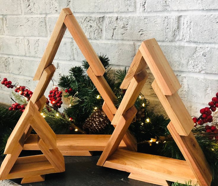 two wooden christmas trees with lights on them