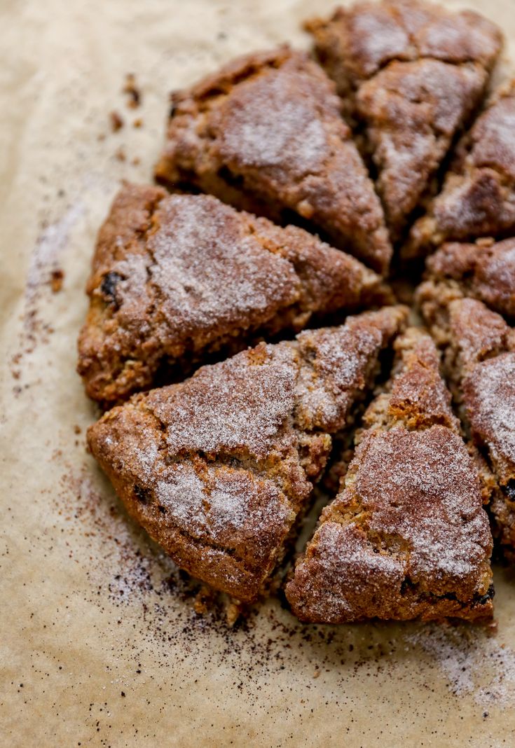 a close up of some food on a piece of parchment paper with powdered sugar