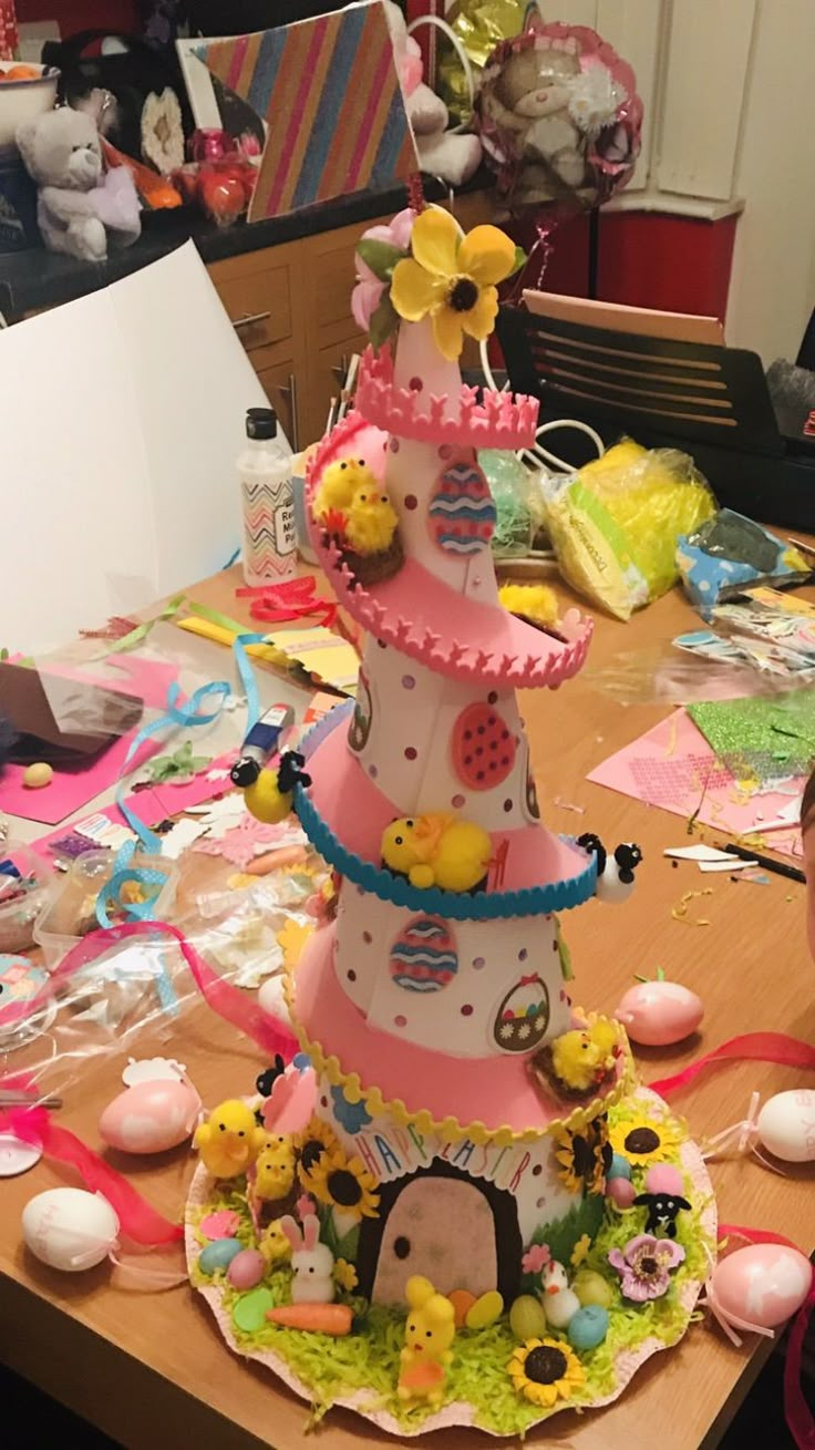 a table topped with a cake covered in lots of different types of decorations on top of it