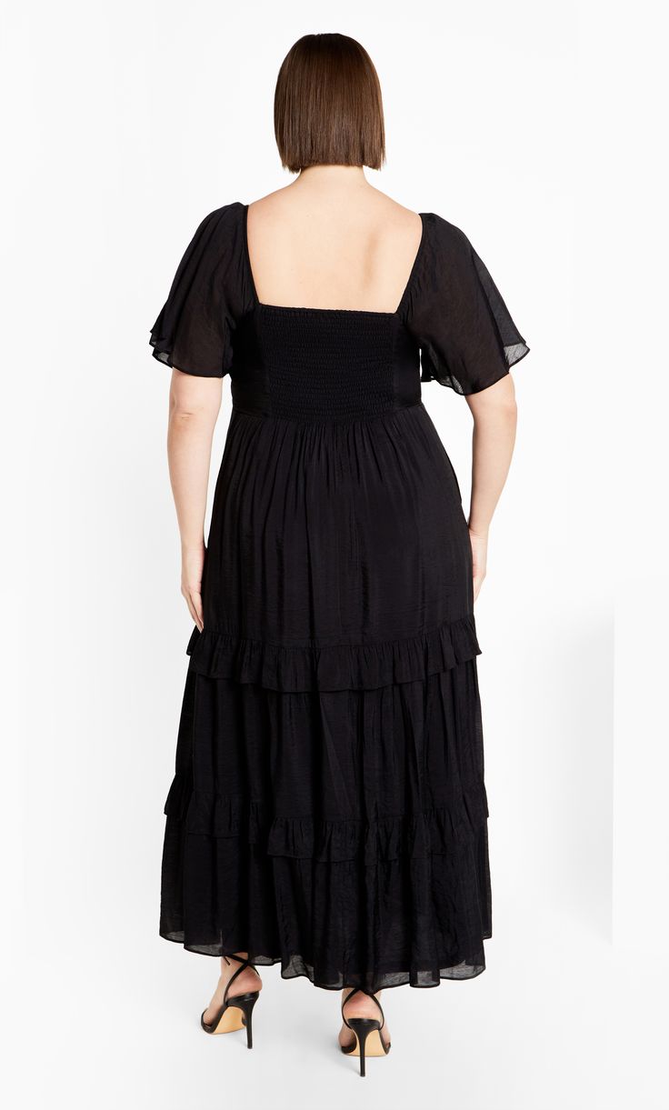 Discover the beauty of the Marci Maxi Dress, offering a sophisticated V-neckline and charming short flutter sleeves. The shirred back delivers a tailored fit, and the tiered skirt enhances its stylish appeal. Complete with functional pockets and a full lining, this dress merges elegance with everyday functionality. Key Features Include: - V-neckline - Short flutter sleeves - Shirred back - Functional pockets - Tiered skirt - Lined - Maxi skirt Style this with a pair of wedges and a fringed jacket for a cowgirl vibe. | Plus Size Maxi Marci 24 in Black, Size 14/XS | City Chic | Plus Size Maxi Dress Marci 24 in Black, Size 14/XS | City Chic Fringed Jacket, Maxi Design, Resort Wear Dresses, Maxi Skirt Style, Ruffle Maxi Skirt, Chic Maxi Dresses, Denim Short Dresses, Tiered Ruffle Dress, Maxi Dress Navy