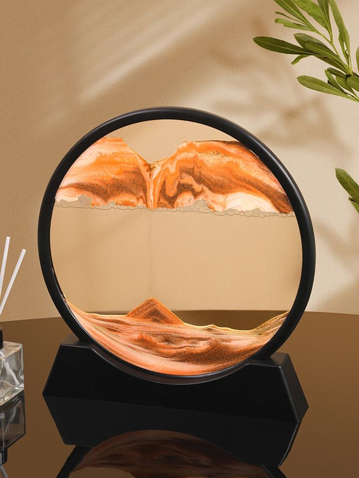 a round mirror sitting on top of a table next to a vase with flowers in it