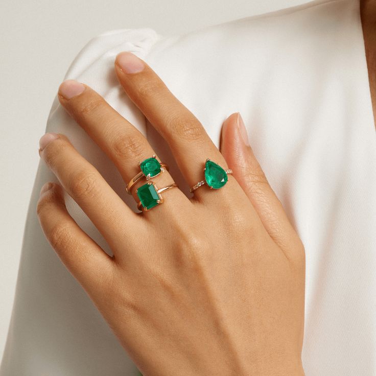 Take your style to the next echelon with the Green Goddess Ring from our Envy collection. Handcrafted by our expert jewelry artisans, the ring is made from 925 sterling silver plated in 14K gold for a hypoallergenic and stunning finish. The showstopping emerald fusion stone glistens with an abundance of beauty that adds an opulent touch. Finished with cubic zirconia, it creates an old-money look while being affordably priced. Metal: 925 Silver Plating: 14K Gold E-coated Size: 6-9 Adjustable Ston Goddess Ring, Drop Ring, Pear Ring, Jewellery Indian, Cushion Cut Ring, Green Goddess, Gold Border, Bridal Jewellery Indian, Bridal Jewellery