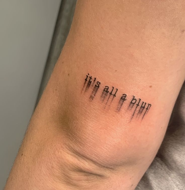 a person with a tattoo on their arm that says, it is all a plot