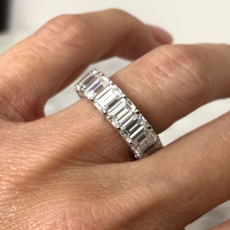 a woman's hand with a diamond ring on it