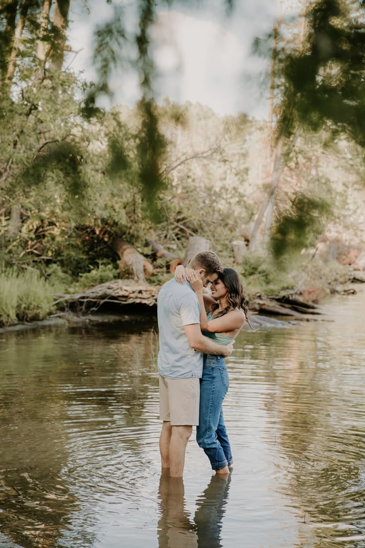 couple standing in lake for engagement photos Couples Water Photoshoot Ideas, Fall Water Engagement Pictures, Couples Creek Photos, Engagement Photo Water, Couples Photo Shoot In Water, Engagement Pictures By Water, Water Pictures Photography Couples, Couples Photoshoot By Water, Couple Poses In Water