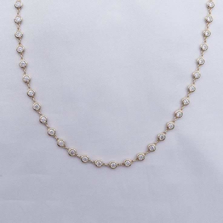 This exquisite 3 3/4 Carat round moissanite diamond necklace features a delicate link chain and a bezel-set design. Expertly crafted with lab-created diamonds in 10K or 14K solid gold and 925 sterling silver, this piece radiates luxury and sophistication. The perfect addition to elevate any outfit. Model No : CSSN1523 Moissanite Necklace In Diamond White With Bezel Setting, Moissanite Necklaces In Diamond White With Bezel Setting, Diamond White Moissanite Necklace With Bezel Setting, Fine Jewelry Moissanite Necklace With Bezel Setting, Moissanite Diamond Necklace With Bezel Setting, White Gold Moissanite Necklace With Bezel Setting, White Diamond Necklace With Bezel Setting, Diamond White Cubic Zirconia Necklace With Bezel Setting, Diamond Tennis Necklace With Bezel Setting As Gift