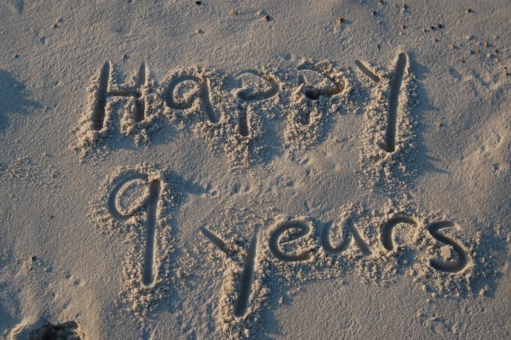 a happy new year written in the sand