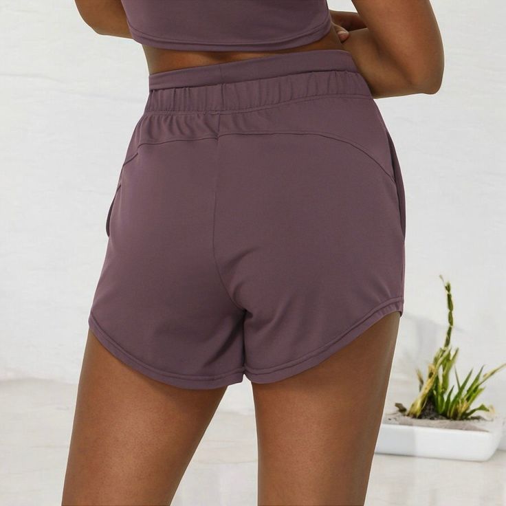 The Anna-Kaci Women's High Waist Drawstring Athletic Shorts offer the perfect blend of style and performance. Featuring a comfortable high-waisted fit with an adjustable drawstring for a customized fit, these shorts are designed for both active days and casual lounging. The lightweight, breathable fabric ensures ease of movement, while the curved hem adds a flattering touch to the overall look. Ideal for working out, running errands, or relaxing at home, these versatile shorts are a must-have in Rise And Run, Bottom Workout, Fitness Trends, Mid Rise Shorts, Woman Weaving, Active Women, Athletic Fits, Bike Shorts, Athletic Shorts