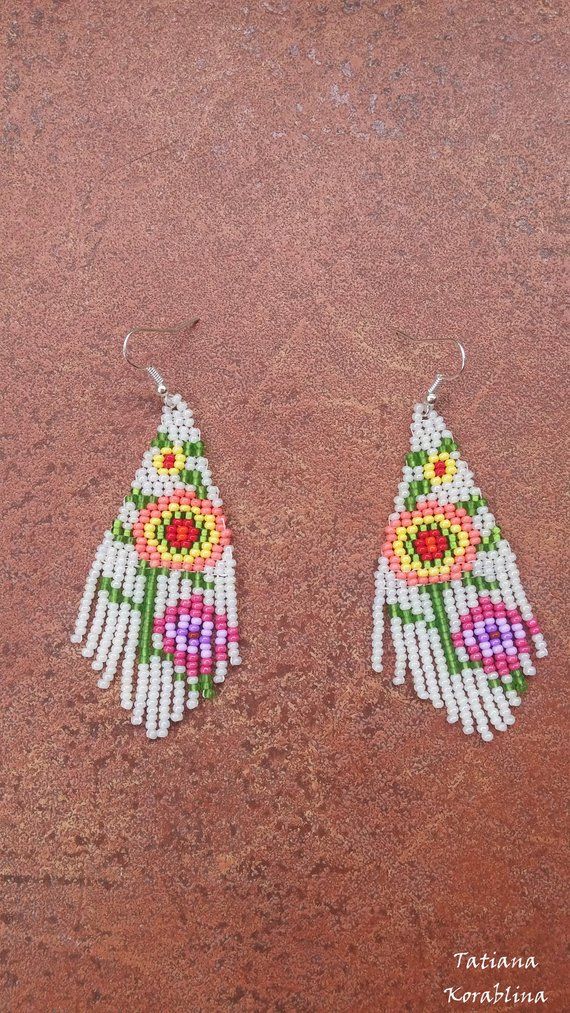 These handmade unique earrings with abstract floral print are made of high-quality Czech beads and strong synthetic thread. They are elegant, fashionable, and highly versatile, suitable for everyday wear. Color: white,pink,red,orange, green . 100% hand made with love! Traditional White Beaded Earrings For Gift, Traditional White Earrings With Ear Wire, Unique White Beaded Earrings For Festival, Traditional White Earrings For Summer, White Flower Drop Earrings For Summer, White Chandelier Earrings For Festival, Traditional White Chandelier Earrings As Gift, Bohemian White Chandelier Earrings For Festivals, Traditional White Chandelier Earrings For Festivals