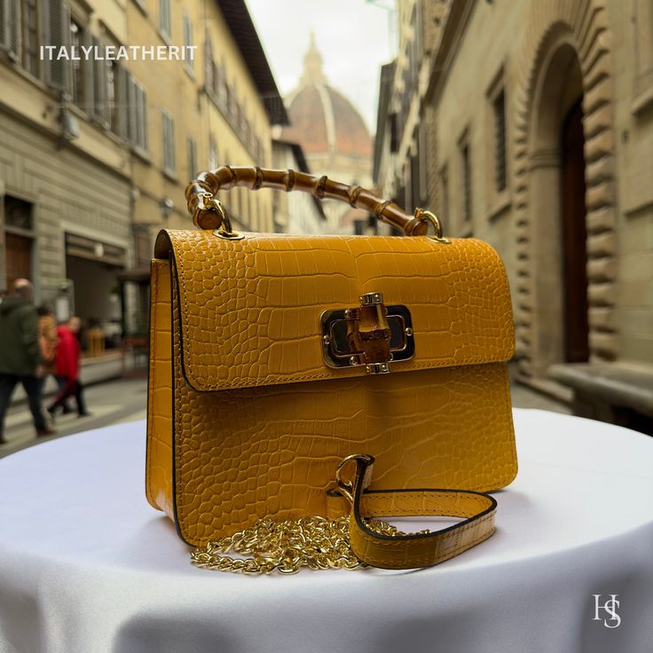 This bag has been made of the best genuine leather by local master crafters of Florence in Italy, designed for women who only accept premium Italian quality and luxury leather bags and modern Italian fashion. . . . Sizes: Width: 22 cm/8.75 inch Height: 16 cm/6.25 inch Depth: 7 cm/2.75 inch The story of this bag: Once upon a time, there was a woman named Sarah who was on the hunt for the perfect tote bag. She had been searching for weeks, scrolling through online shops and visiting stores in her city, but nothing seemed to catch her eye. One day, she stumbled upon a small leather shop in the heart of the city, and as she walked inside, she was mesmerized by the beautiful array of leather goods on display. She was immediately drawn to a stunning yellow leather tote bag with a Mexican-inspire Luxury Yellow Satchel For Office, High-end Rectangular Bag With Leather Lining, Designer Leather Flap Bag As Gift, Designer Leather Bags As Gifts, Designer Leather Bags For Gift, Designer Leather Bags For Gifts, Luxury Leather Flap Bag As Gift, Luxury Leather Flap Bag Gift, Luxury Leather Flap Bag For Gifts