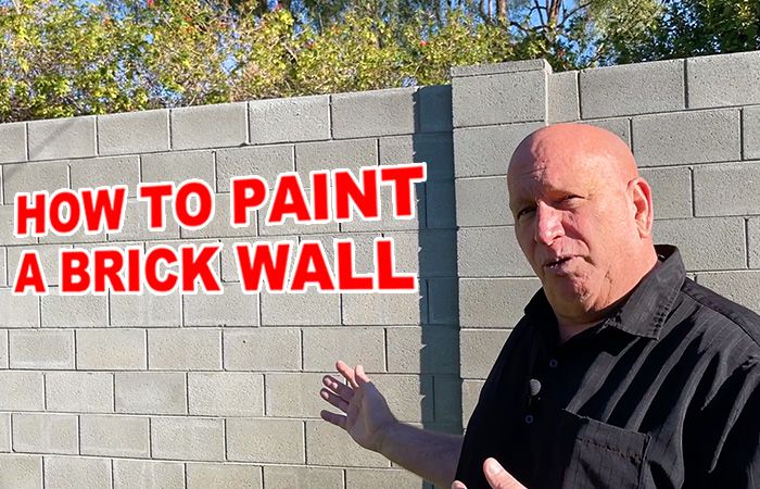 a man standing in front of a brick wall with the words how to paint a brick wall