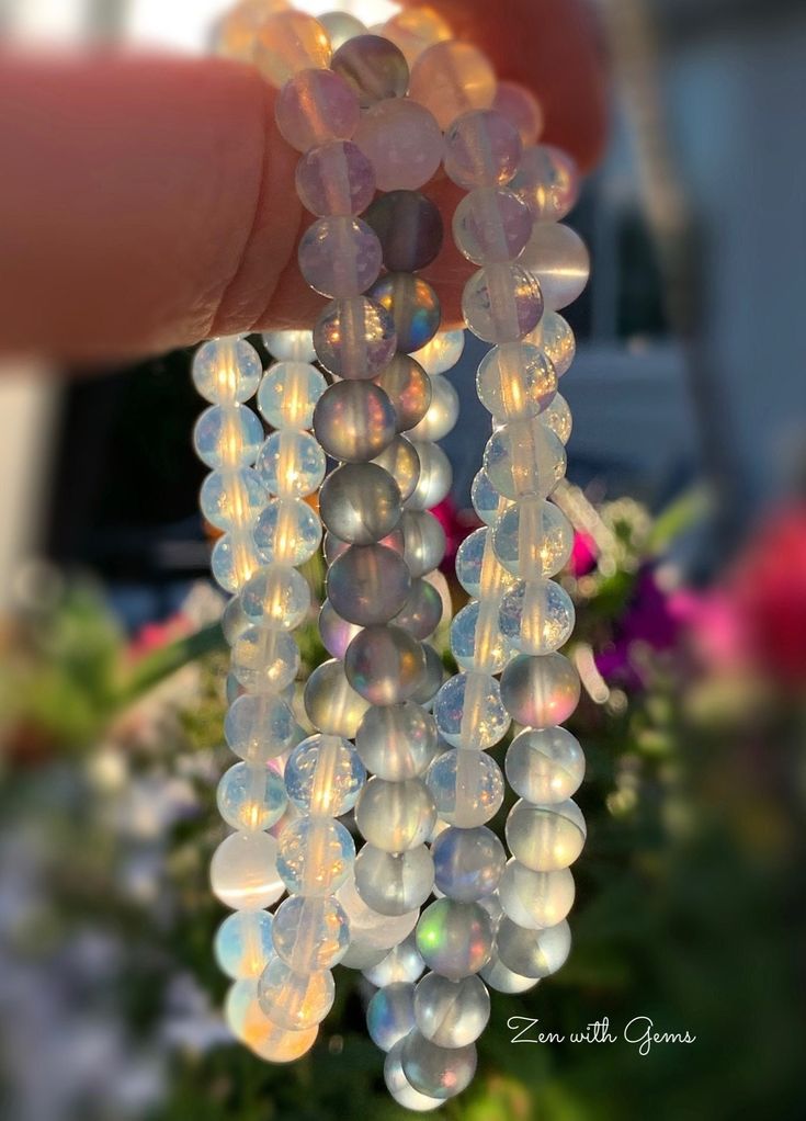 I loved making these Joy Bracelets. Each one is made with two Selenite beads, and then a mix of opalite and mermaid beads. Opalite and mermaid beads are synthetic made beads. I love the Joy these bracelets bring with these beautiful beads. These are made with stretchy cord, and are approximately 7 inches in diameter. I will intuitively choose the piece for you. There might be imperfections on the beads. The picture is a sampling of the bracelets, yours may vary in color from the picture. This li Moonstone Crystal Bracelet With 8mm Round Beads, Moonstone Crystal Bracelet With Round 8mm Beads, Iridescent Round Beads Crystal Bracelet For Jewelry Making, Spiritual Iridescent Crystal Bracelet With Round Beads, Moonstone Crystal Bracelet With Gemstone Beads, Handmade Iridescent Bracelets With Round Beads, Moonstone Gemstone Beads Crystal Bracelet, Handmade Moonstone Crystal Bracelet, Spiritual Iridescent Crystal Bracelet