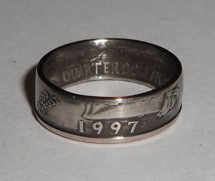 an old silver ring with the date 1917 engraved on it's side, sitting on a white surface