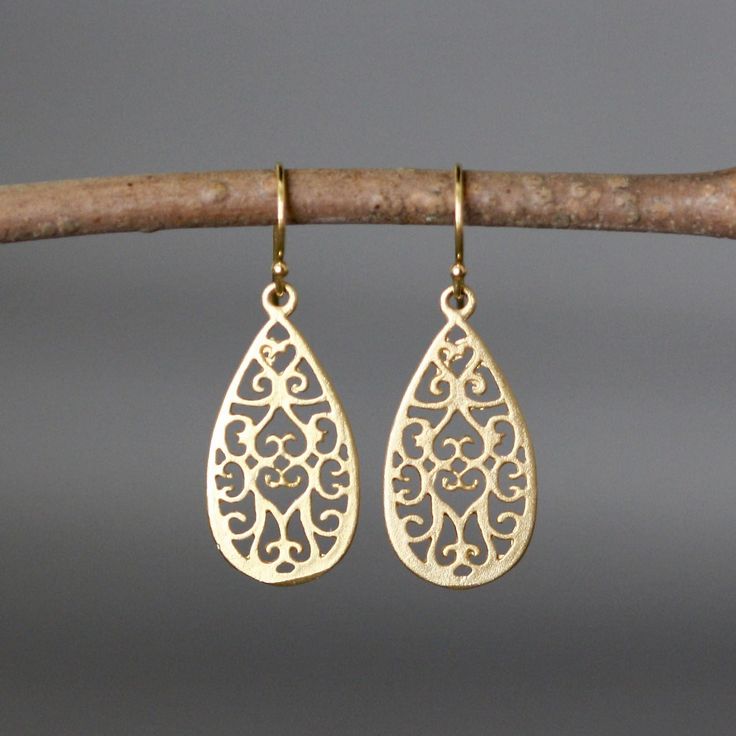 "Beautifully detailed matte gold vermeil filigree teardrop charms simply dangle from gold vermeil balled earwires. Incredibly lightweight, these go-with-everything earrings complete any outfit for daytime or evening. These earrings are also available in silver. Gold charms: 13x26mm Total length of earrings: 1 1/2\" All gold is 18k gold vermeil. As the owner, maker, designer, and curator of this shop, I take great pride in providing you with jewelry that you will love to wear everyday, for specia Elegant Matte Gold Earrings For Formal Occasions, Dainty Gold Earrings With Elegant Design, Elegant Teardrop Brass Earrings, Yellow Gold Teardrop Bridal Earrings For Pierced Ears, Elegant Matte Gold 14k Gold Earrings, Elegant Filigree Teardrop Drop Earrings, Elegant Brass Teardrop Earrings, Elegant Brass Teardrop Dangle Earrings, Elegant Filigree Teardrop Earrings For Gift