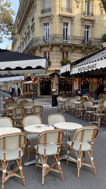 tables and chairs are lined up on the street