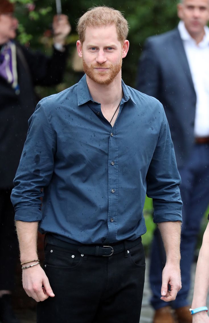 a man in a blue shirt and black pants