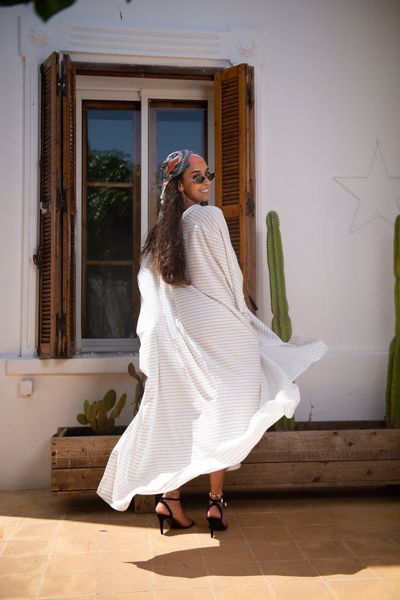 Handmade black and white stripes kaftan, designed with handmade silk pompoms. very loose and flattering to any body type.pair it with heels or flats. Must have style in any wardrobe.DETAILSViscose, linenFront Handmade Silk pompomOne size fits allThis is a very loose kaftan. The model wears SmallDry clean onlyHandmade in Morocco.Got a question!! don't hesitate to contact me :) Striped Long Sleeve Maxi Dress For Vacation, Striped Kaftan For Summer Beach Cover-up, Striped Maxi Dress For Beach Cover-up, Striped Bohemian Maxi Dress For Summer, Bohemian Striped Maxi Dress For Summer, Striped Long Maxi Dress For Summer, Casual Vertical Stripes Maxi Dress For Beach, Casual Striped Maxi Dress For The Beach, Casual Maxi Dress With Vertical Stripes For The Beach