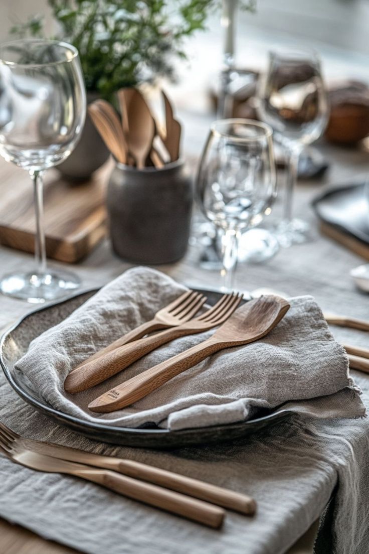 a table set with silverware and wooden utensils