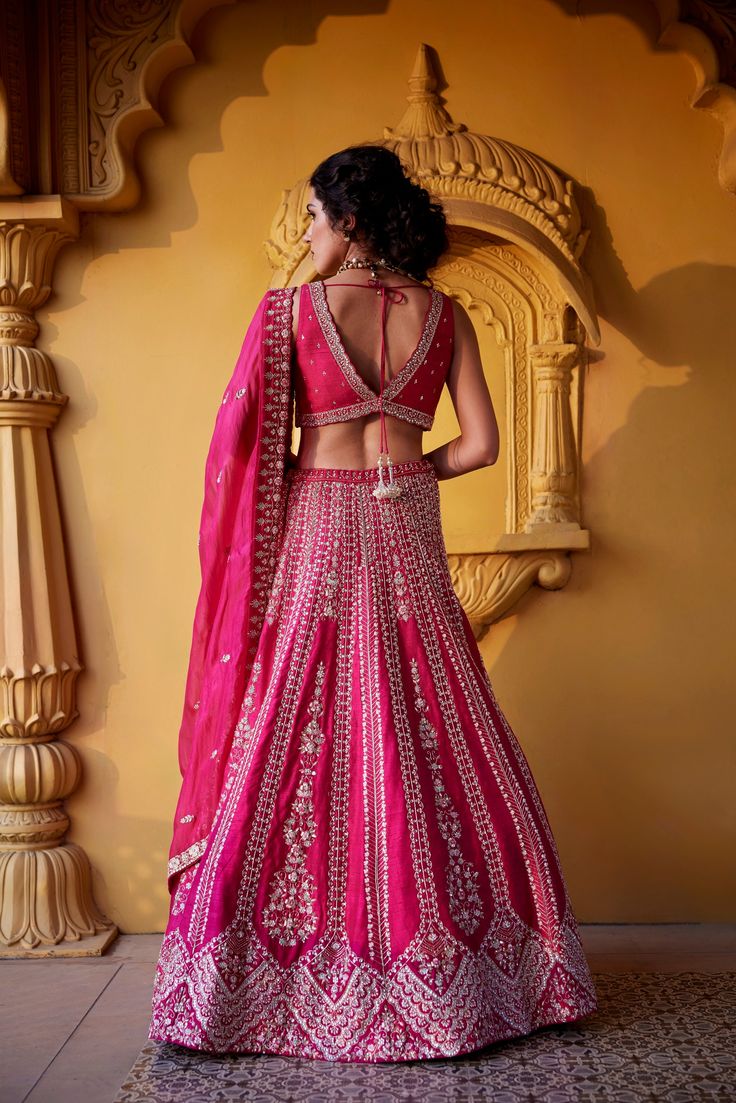 Pink raw silk flared skirt with intricate zardozi, kundan, glass beads and resham embroidery paired with deep v neckline raw silk embroidered blouse and organza dupatta with embroidered borders and zardozi and pearl buttis.From Chamee and Palak's The Romantics collection.DELIVERY TIMEPlease allow 8-12 weeks for your outfit to arrive.FABRIC DETAILSRaw Silk, OrganzaProfessional cleaning only. Raw Silk Lehenga, Resham Embroidery, Pink Lehenga, Indian Wedding Wear, Organza Dupatta, Bridal Lehenga, Flared Skirt, Bride Bridal, Indian Design