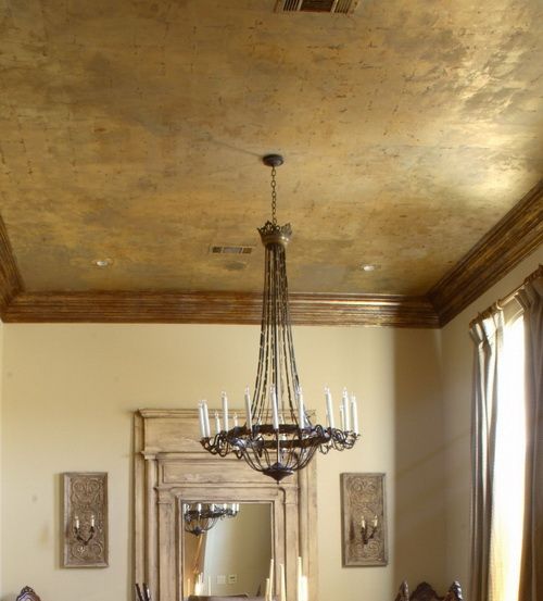 a dining room table with chairs and a chandelier hanging from it's ceiling