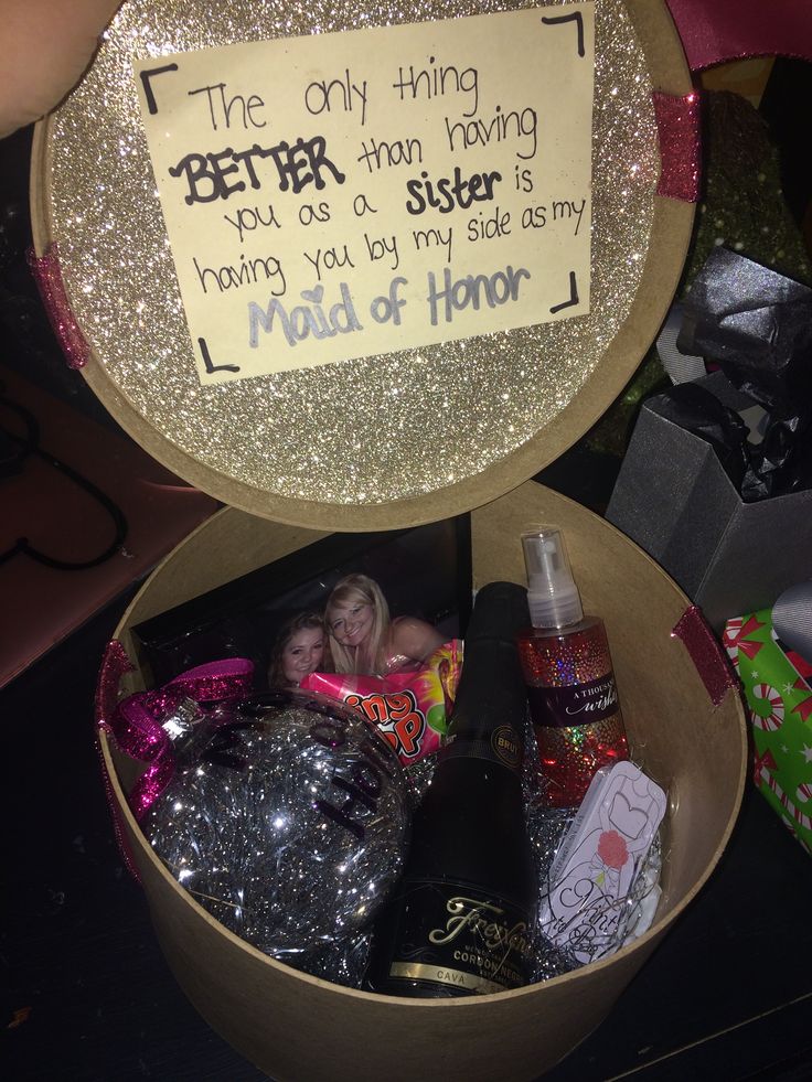 a gift box filled with personalized items and a note on the lid that says, the only thing better than having you as a sister