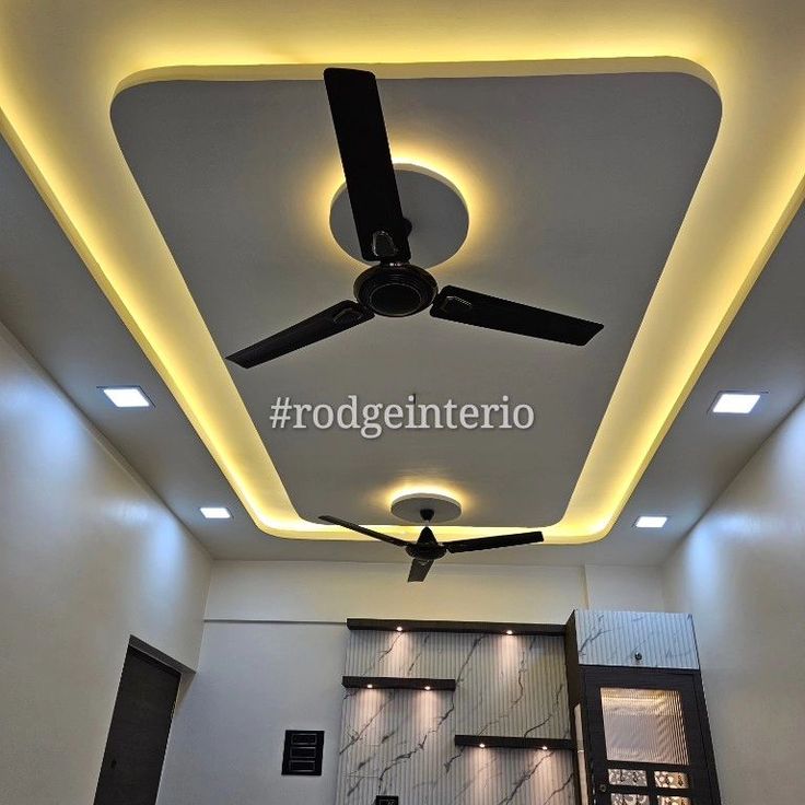 the ceiling fan is lit up in an empty room with white walls and black flooring