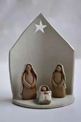 two nativity figurines sitting in front of a star