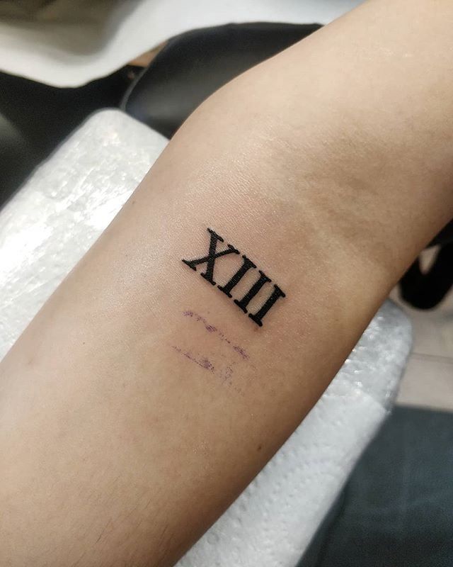 a person with a tattoo on their arm that says xix in roman numerals