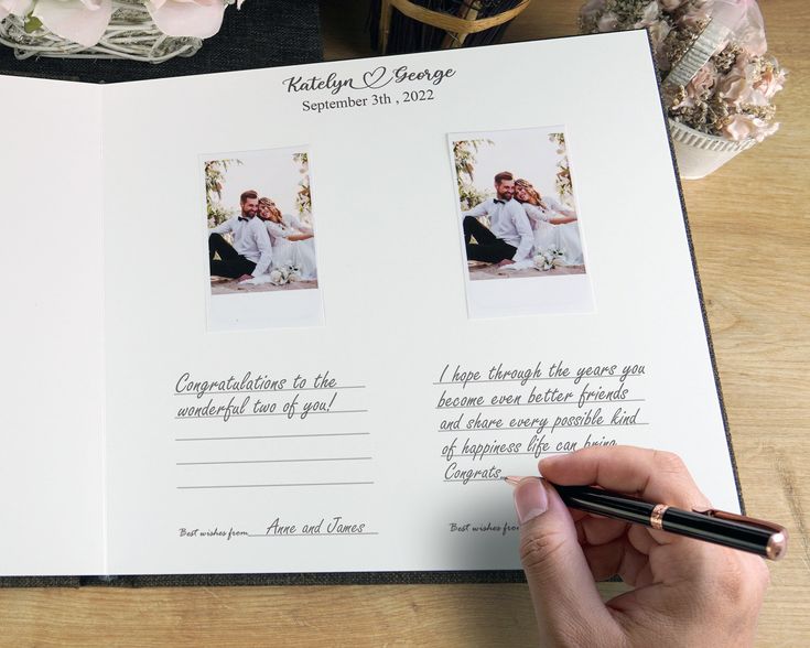 a person holding a pen and writing on a wedding album with two photos in it