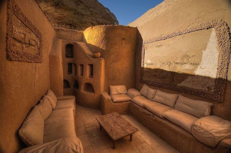 an adobe - style living room with couches and tables