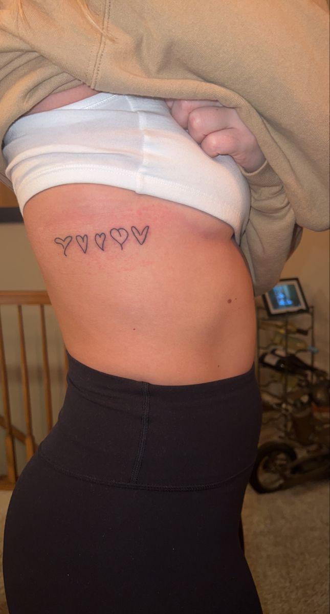 the back of a woman's stomach with hearts on it