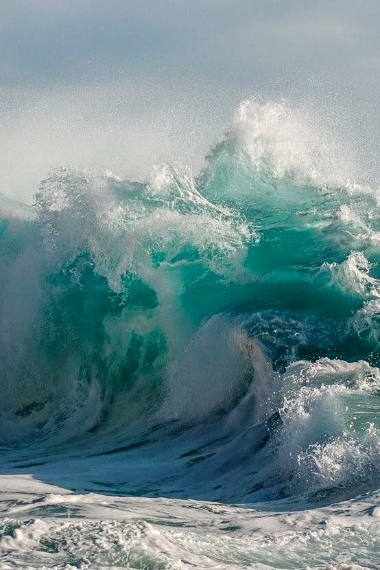 an ocean wave crashing into the shore with foamy water on it's surface