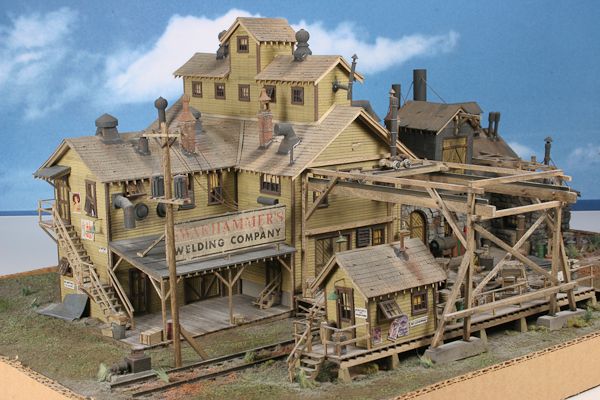 a wooden model of a building with stairs leading up to the top floor and second story