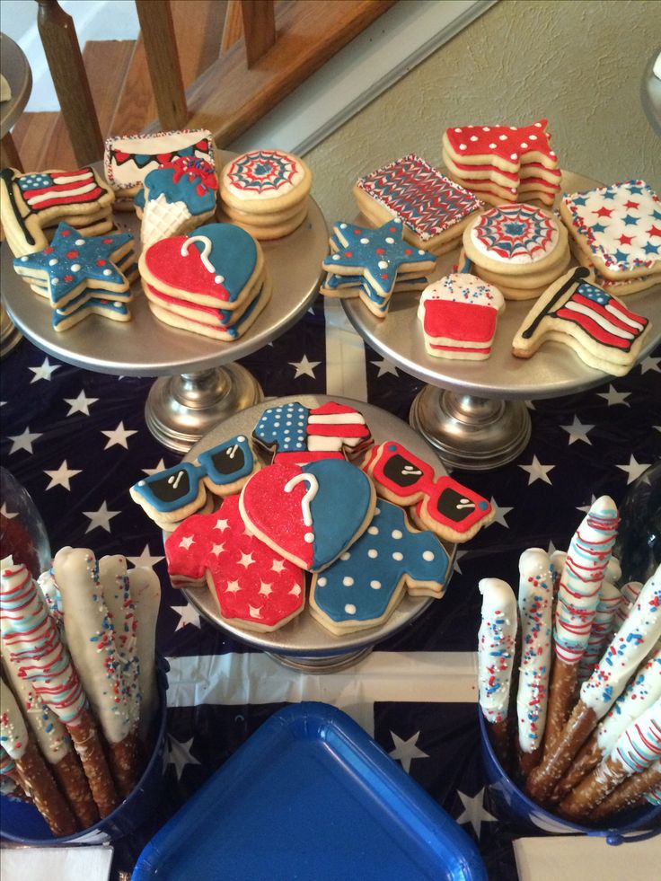 patriotic cookies and desserts are displayed on plates