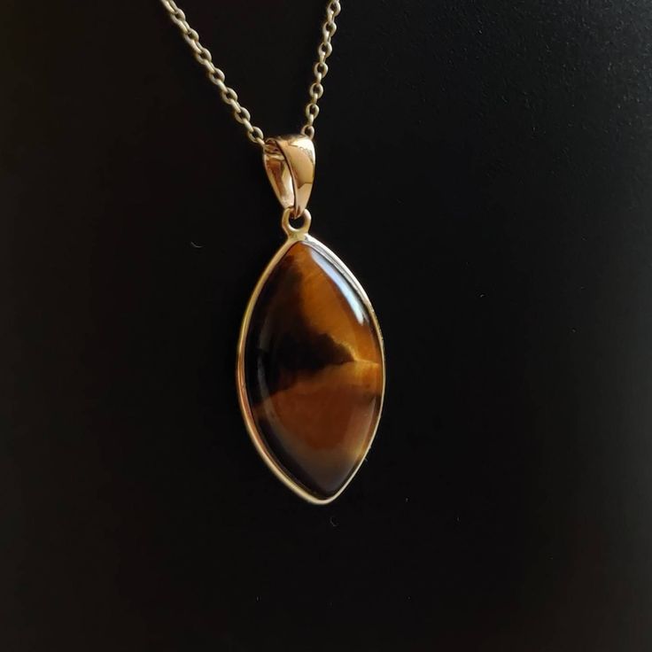 ITEM DESCRIPTION: >>The pendant is made from Solid 14K Yellow Gold. Gemstone used is absolutely natural and ethically sourced. >>Natural Tiger Eye in cabochon marquise shape with bezel setting is studded on it with utmost precision. >>This is a minimalist design and is absolutely hassle-free and everyday jewelry. Gem: Tiger Eye Gem size: 12x22 mm Marquise Gem weight: 11.55 carats Gold purity: 14K (58.33% approx.) Gold weight: 0.58 grams Gross weight: 2.89 grams The Gold purity is guaranteed and 14k Gold Gemstones With Bezel Setting For Gift, Fine Jewelry Cabochon Gemstone Pendant, Anniversary Fine Jewelry Necklace With Cabochon, Anniversary Fine Jewelry Cabochon Necklace, Anniversary Cabochon Fine Jewelry Necklace, Teardrop Pendant Jewelry With Bezel Setting, Gift Jewelry Teardrop Pendant With Bezel Setting, Gift Jewelry With Bezel Setting In Teardrop Pendant Shape, Gift Teardrop Pendant Jewelry With Bezel Setting