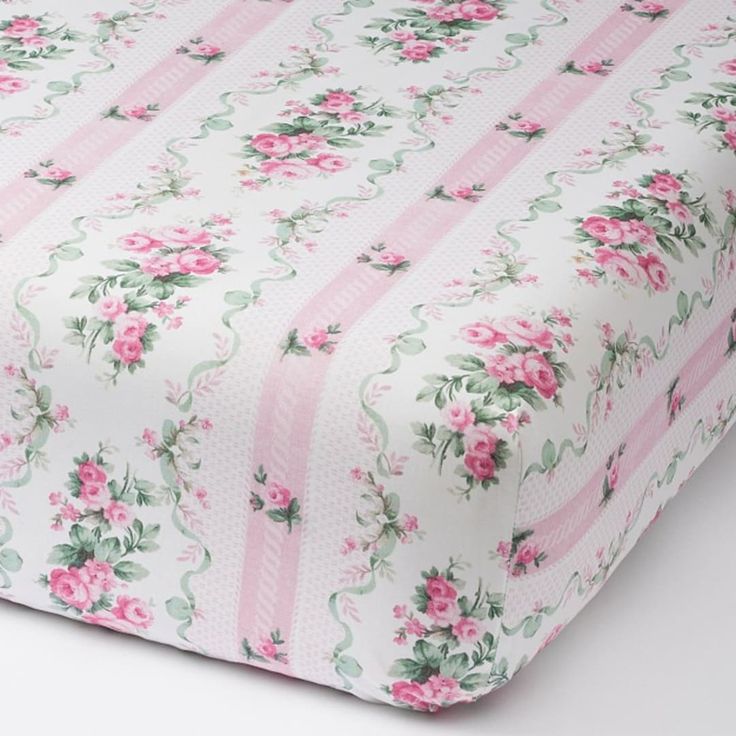 a sheet with pink flowers and stripes on it