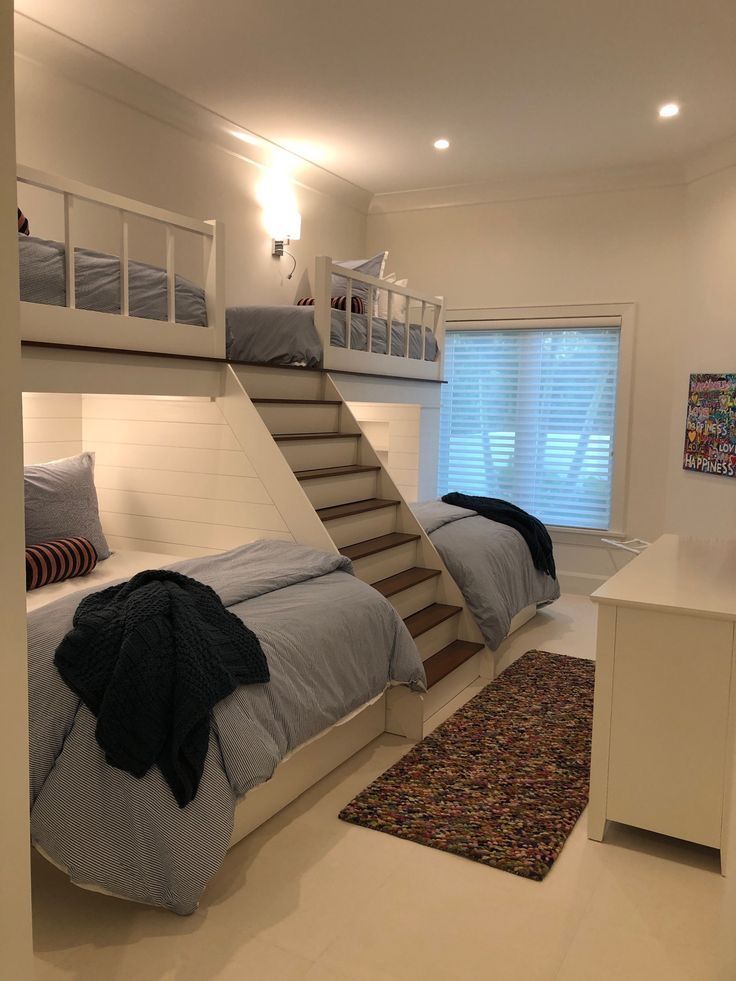 a bedroom with bunk beds and stairs in it