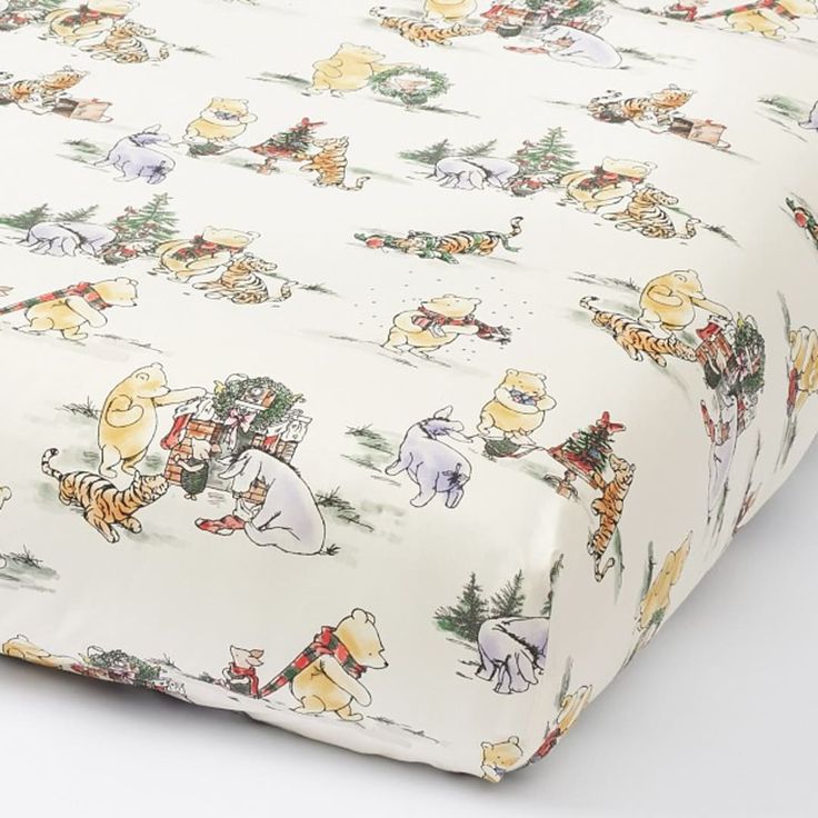 the winnie the pooh bedding set is made up of white sheets with winnie the pooh characters on them