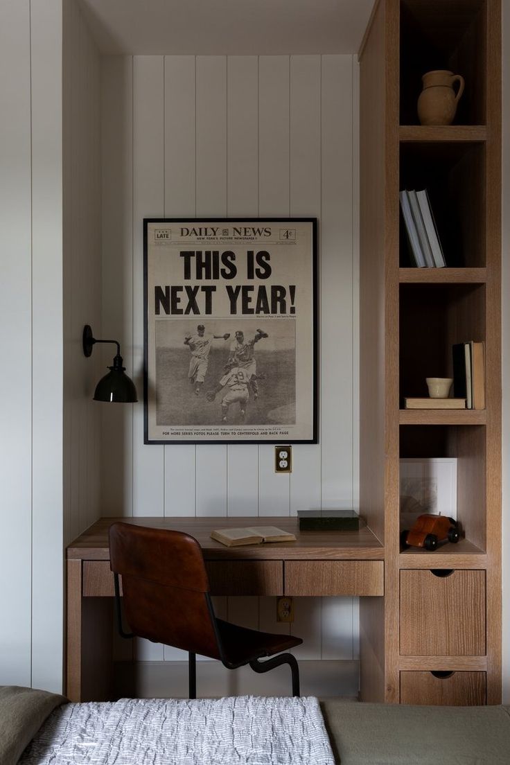 a bedroom with a bed, desk and bookshelf next to a book shelf