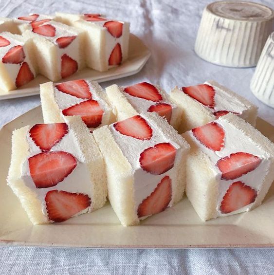 several slices of cake with strawberries on them