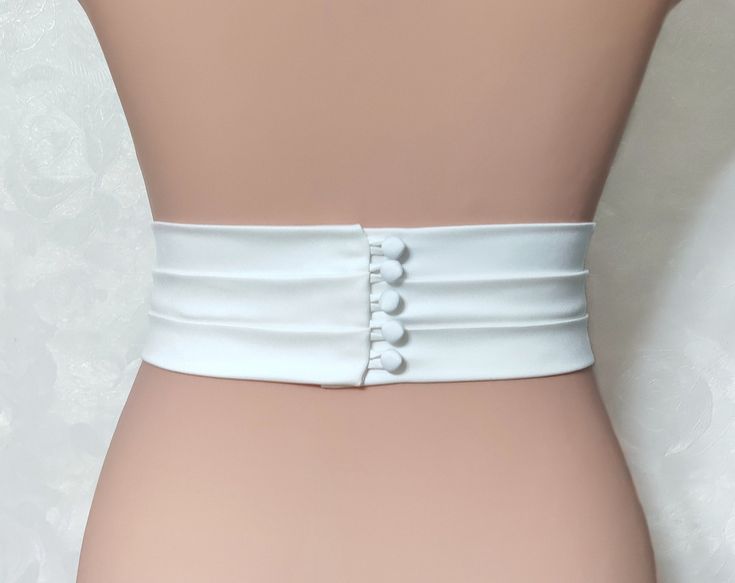 "Introducing our handmade Burgundy Bridal Belt, a stunning accessory that will add an elegant touch to your wedding dress. Made from top-quality Italian mulberry silk, this belt features a tight elastic band base for a comfortable fit. With a width ranging from 1/2\" to 3\", you can choose the perfect size to complement your gown. Fabric belts: Italy mulberry silk\\ Satin Duchess\\ Matte satin\\ Satin crepe + tight elastic band base. Length: As requested Clasp design: - minimalism. Clean smooth edge without decorative elements; - bow. Delicate silk bow; - buttons (pearl buttons, silk-covered buttons). Shine level: Matte satin - 1 points Satin Duchess - 2 points Mulberry silk - 3 points Satin crepe - 5 points The clasp design options include a minimalistic style with a clean, smooth edge, a Elegant Fitted Corset Belt With Belt Loops, Elegant Corset Belt With Belt Loops, White Bridal Belt For Bride, Wedding Sashes With Satin Finish, Elegant White Sash For Formal Occasions, Elegant White Corset Belt For Party, Elegant Fitted White Corset Belt, Formal Cream Fitted Bridal Accessories, Elegant White Bride Sashes