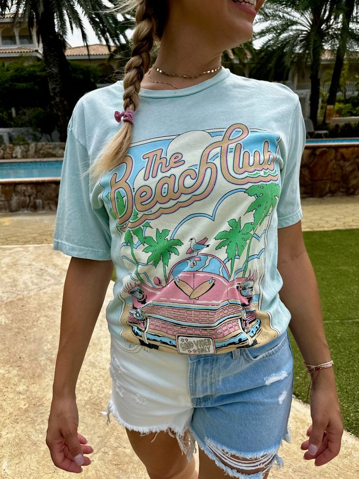 This Lotus Boyfriend Graphic Tee is the perfect laid-back look. Loose in all the right places, its open neckline and slightly dropped sleeves make it ideal for your beach days. With a Mineral Wash and a hand-drawn exclusive graphic, this tee is sure to be your new summer fave! Go get 'em, beach babe! Color: Mint or Light Pink Fabric: 100% Cotton Brand: Lotus Fashion Collection Made: El Salvador Includes: x1 Graphic T-Shirt Sizes: S-XL, Regular Sizing Retro Summer T-shirt With Front Print, Retro Printed Summer T-shirt, Blue Beach T-shirt With Front Print, Fun Beach T-shirt With Sublimation Print, Beach Season Short Sleeve T-shirt For Day Out, Fun Summer T-shirt For Beach Party, Vintage Summer Beach T-shirt, Retro Summer Tops With Letter Print, Casual Blue T-shirt For Beach Party