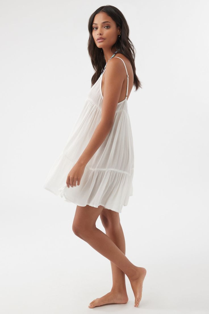 Complete your beach look with this flowy cover-up dress. It has a mini length fit and tiered detail. O'Neill Women's Cover-up dress Mini length Tiered skirt 100% Viscose Flowy V-neck Tiered Dress For Vacation, Flowy Sundress For Brunch During Beach Season, White V-neck Tiered Dress For Summer, Breezy Mini Dress For Beach Cover-up, V-neck Tiered Dress With Ruffle Hem For Beach, Beachwear Mini Dress For Brunch, Unlined Spaghetti Strap Vacation Dresses, Vacation Dresses With Spaghetti Straps, Summer Mini Dress For Beach Season