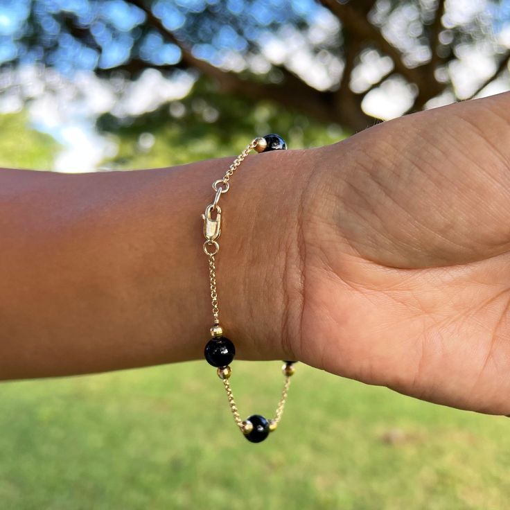 Gift yourself a unique gem that is only from Hawaiʻi. The Hawaiian Black Coral Bracelet in Gold features high-polished and sustainably harvested Hawaiian black coral beads with accenting gold beads and a gold chain. The dramatic contrast will go beautifully with various looks. Bracelet 14k Yellow Gold 8-8.9mm Hawaiian Black Coral Beads Gold Beads Approximately 7.5"-8" in length Locally Made in Hawaiʻi Forever Guarantee (Lifetime Warranty on the life of the piece) Free Shipping on USA Orders $100 Bracelet Or, Black Coral, Coral Bracelet, Gem Earrings, Drop Design, Yellow Gold Bracelet, Black And Yellow, Coral Beads, Gold Beads