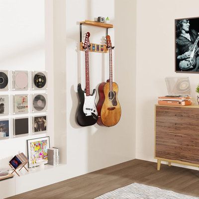 a living room with guitars hanging on the wall